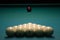 Balls for Russian Billiards are lined with a pyramid at the beginning of the game. white balls on a green table. serious sport,