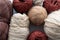 Balls of various yarns for knitting woolen nylon and acrylic of different shapes in classic colors of brown and beige in the whole