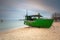 Baltic beach in Gdynia Orlowo with fishing boat at dawn, Poland