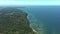Baltic coastline with green summer forest and the sea. Aerial view