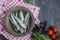 Baltic herring seafood. Salted herring fish in a bowl with spices and herbs. Wood background