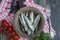 Baltic herring seafood. Salted herring fish in a bowl with spices and herbs. Wood background