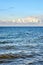 Baltic Sea with sailboat and industrial ship under beautiful clouds