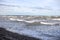 Baltic sea shoreside view with waves and cloudy weather