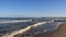 Baltic Seashore With Wave Breaking And Brown Sand