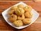 Balushahi an Indian Traditional Sweet Food served over a white plate on a rustic wooden background, selective focus