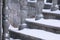 Balustrade of the rotunda under the snow. Gray granite exterior details during a snowfall. Fragment of a city landmark