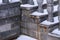 Balustrade of the rotunda under the snow. Gray granite exterior details during a snowfall. Fragment of a city landmark