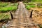 Bamboo bridge crossing stream