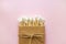 Bamboo cotton sticks in paper box bound with flax or hemp cord on light pink background. Copy space, eco friendly concept