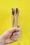 Bamboo eco toothbrushes with multicolored bright bristles. Toothbrushes in a male hand like a bouquet.