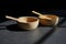 Bamboo food bowl container with wood spoon on black background.