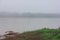 Bamboo hut on riverside covered by mist