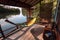 Bamboo hut on riverside with hammock, wooden terraces and guide-book for travelers in Southeast Asia