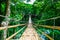 Bamboo pedestrian suspension bridge over river