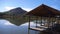 Bamboo Pier At A Lake Side With Reflection Of Green Mountain - Pan - Left To Right