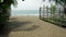 Bamboo pole fence on a tropical island. white sandy beach with palm-lined shore.