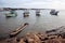 A bamboo raft, and fishing boats tied along the shore