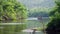 Bamboo raft in River Kwai with tree and mountain and blue sky