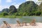 Bamboo terrace chairs view lake karst mountains, Ninh Binh, Vietnam