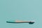 Bamboo toothbrush on blue mint background