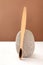 Bamboo toothbrush and stone on pastel brown background