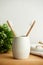 The bamboo toothbrushes in a gray glass