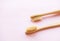 Bamboo toothbrushes on light pink background