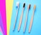 Bamboo toothbrushes on multicolored bright background in trendy colors. Eco-friendly products