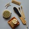 Bamboo toothbrushes, natural soap and bath loofah on a plate and other eco-friendly body care products on a paper background.