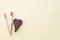 Bamboo toothbrushes and wooden heart on yellow background