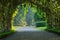 A bamboo tunnel with different kinds of hanging vegetables growing on it, in a Thai garden park.