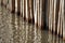 Bamboo wall sticks at water surface selective focus