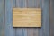 Bamboo wood cutting board on a wooden gray background