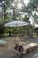 Bamboo wooden bed chair with pillow and white umbrella in the garden park with sunshine in thailand , relaxation lying asleep recr