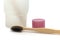 Bamboo wooden eco toothbrushe with charcoal coating, glass cup, toothpaste cap on white background