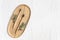 Bambool toothbrush and leaves of eucalyptus on a wooden plate.