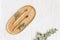 Bambool toothbrush and leaves of eucalyptus on a wooden plate.