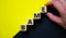 BAME symbol. Abbreviation BAME, black, asian and minority ethnic on wooden cubes. Beautiful yellow and black background. Copy