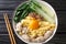 Ban Mian Chinese egg noodle soup with anchovies, meatballs and pak choi close-up in a bowl. horizontal top view