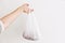 Ban single use plastic. Woman holding in hand groceries in plastic polyethylene bag. Zero Waste shopping concept.  Reuse, reduce,