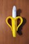 Banana baby teether on wooden background