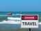 The banana boat ride with tourists and the danger travel sign on the beach.