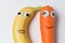 Banana and carrot with Googly eyes and painted smiles. Products with funny faces