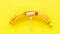 Banana with carved on it charging sign and cable on yellow background