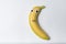 Banana character with funny face on white background. Banana with Googly eyes and painted smile