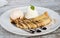 Banana crepes with vanilla ice cream and home made whip creme, glaze with chocolate and honey