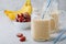 Banana and date fruit smoothie or milkshake in glass mason jar