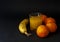 Banana and group of tangerines, mandarins with glass of juice dr
