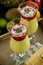 Banana and mango smoothie dessert in wine glasses